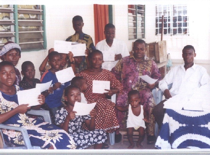Teachers and children with Promise Books in Togo
