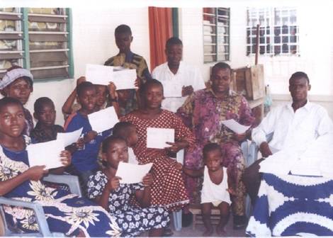 children and teachers receiving promise books